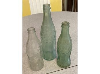 Three Vintage Coca Cola Bottles