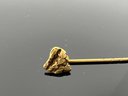LOT 63 - GOLD NUGGET PIN - (NUGGET IS GOLD - PIN ITSELF UNKNOWN)