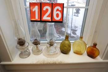 LOT 126 - OLD BOTTLES AND OIL LAMPS IN WINDOW SILL