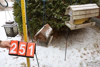 LOT 251 - 3 BIRD FEEDERS - POLES CAN GO IF CAN GET THEM OUT - MUST WALK A WAYS TO BACK YARD