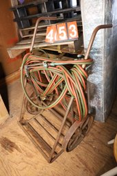 LOT 453 - REALLY OLD METAL DOLLY AND HOSES - VERY HEAVY - BRING ASSISTANCE - ABOVE BARN