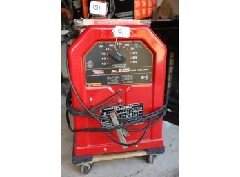 AC225 ARC WELDER AND FLOOR DOLLY MARKED 151