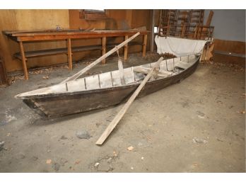 VERY OLD CANOE WITH PADDLES