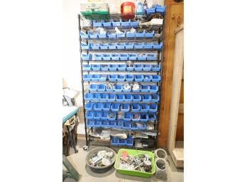 LARGE BLUE CUBBY HARDWARE STORAGE RACK AND THING INSIDE AND BELOW IT.