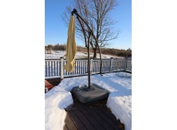 OUTDOOR UMBRELLA AND BASE - LOCATED BEHIND HOUSE ON DECK!
