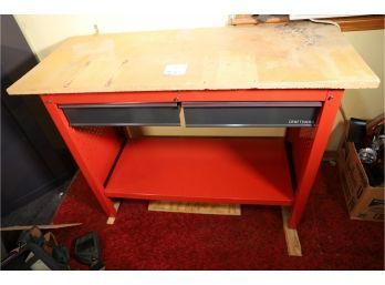 RED WORKBENCH (TABLE TOP HAS WATER DAMAGE IN CORNER AS SHOWN. COMES AS SHOWN