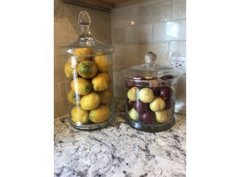 TWO GLASS LARGECANISTERS FILLED WITHPLASTIC  FRUIT