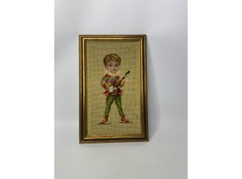 NEEDLE POINT OF A BOY PLAYING AN INSTRUMENT, 14X9 INCHES