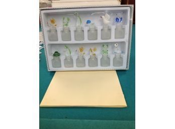 Box Of Murano Glass Bottles With Assorted Animals On Top