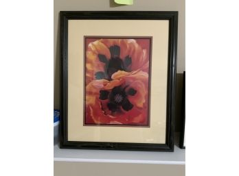 PRINT OF BLAKC AND RED FLOWERS ON A BLACK WOOD FRAME 18X21.5 INCHES