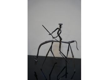 WELDED METAL ABSTRACT FIGURINE OF A PERSON IN A HORSE