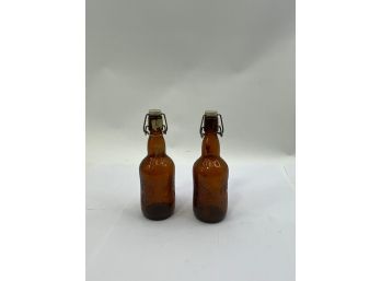 LOT OF 2 ANTIQUE BROWN GLASS BOTTLES WITH TOPPERS