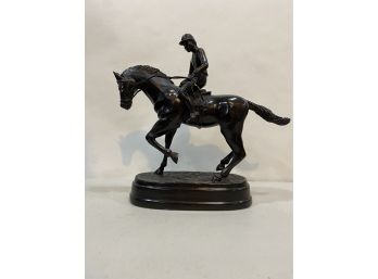 METAL STATUE OF A MAN ON A HORSE