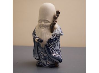JAPANESE BLUE AND WHITE FIGURE OF A SAGE WITH PAPER LABEL BY TOYO JAPAN, 11.5 INCHES HIGH