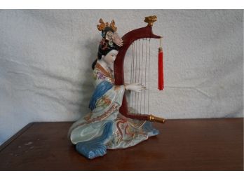 PORCELAIN FIGURINE PLAYING AN INSTRUMENT, 6IN HEIGHT