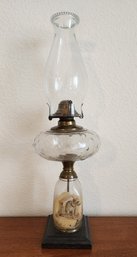 Antique Oil Lamp With Cast Iron Base And Applied Dog Painting Accent