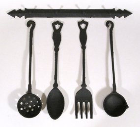 VINTAGE SET OF FOUR DECORATIVE CAST IRON KITCHEN TOOLS WITH HANGER IN ORIGINAL BOX, 1970s
