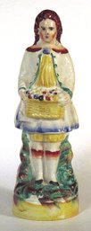 ANTIQUE STAFFORDSHIRE FIGURE OF A GIRL WITH BASKET, CIRCA 1840 - 60