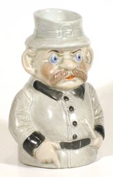ANTIQUE FIGURAL BISQUE NOVELTY MUG IN THE FORM OF A POLICEMAN WITH BILLY CLUB, GERMANY, CIRCA 1900 - 10