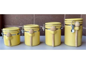 (4) Piece Yellow Flip-top Ceramic Canister Set With Wooden Spoons