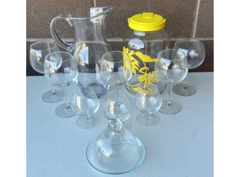 Assorted Collection Of Glassware Including Sweet Tea Jar, Pitcher, Wine Glasses, And More