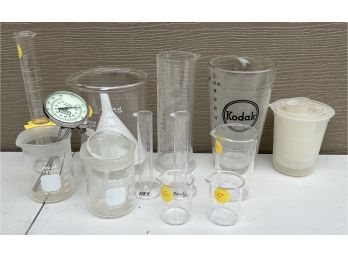 Collection Of Plastic And Glass Beakers, Measuring Cups, Thermometers, And Funnels - Kodak And Pyrex