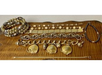 (8) Gold Tone And Hematite Bracelets