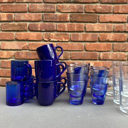 Clear And Blue Glass Ware And Blue Glazed Mugs 27 Pieces