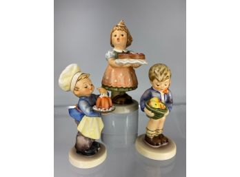 Three M.J. Hummel Figures. With Food