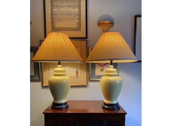Pair Of Pale Yellow Ceramic Jar Lamps With Black Wooden Base