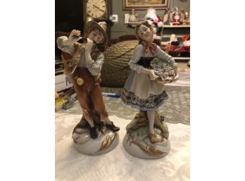 Pair Of German Porcelain Figurines - Boy Playing Flute And Girl Carrying Basket Of Flowers - SHIPPABLE