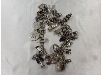 PAIR OF STERLING SILVER CHARM BRACELETS