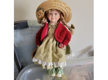 Porcelain Doll Holding A Basket Of Apples