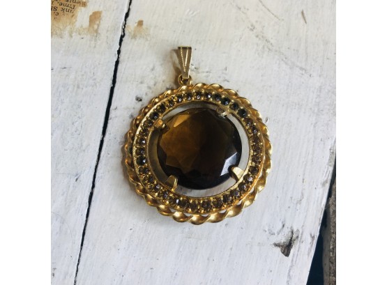 Gold Tone Pendant With Amber Colored Center