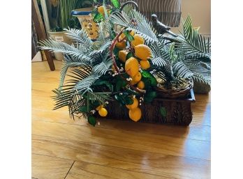 Ornate Metal Shelf With Two Wicker Pots And Faux Lemon Trees (Living Room)