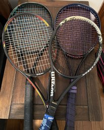 Collection Of Used Tennis Racquets With Bags