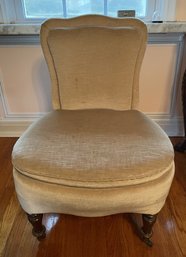 CREAM COLORED SLIPPER CHAIR IN THE STYLE OF JOHN DERIAN