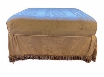 VINTAGE OTTOMAN WITH FRINGED SLIP COVER