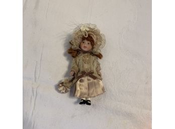 Small Porcelain Doll With Red Curls