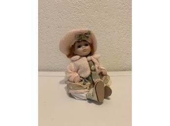 Small Porcelain Doll With Pink Jacket And Hat