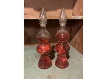 Decanters With Red Liquid And Faux Flowers