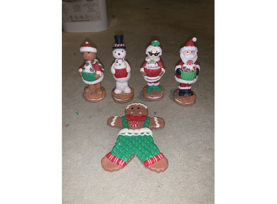 Cute Little Christmas Figurines Standing On Cookies And Gingerbread Boy