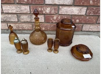 Amber Glass Assortment Including Bell, Decanter, And More