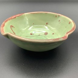Signed Pottery Bowl, 2015 EM, Green Color With Maroon Splatter And Rim, Pinched Circle Shape