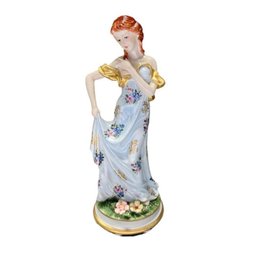 Grace And Glamour: Porcelain Figurine Of Woman In Blue & Gold Dress