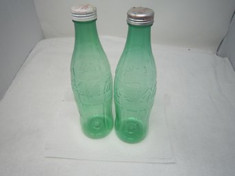 Two Plastic Coca Cola Bottles