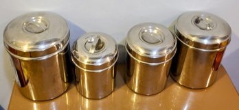 Set Of Four Metal Kitchen Storage Canisters With Lids Of Varying Sizes