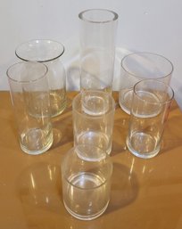 Seven Round Glass Vases Of Various Sizes
