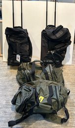 Two Black Netpack Bags With Wheels Paired With Two Army Green Eddie Bauer Duffel Bags