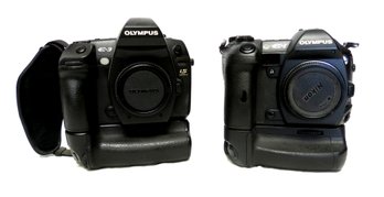 2 Olympus DSLR Camera Bodies E-3 And E-1 With Battery Holders